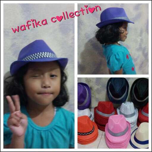 a little girl wearing a hat and a hat.
