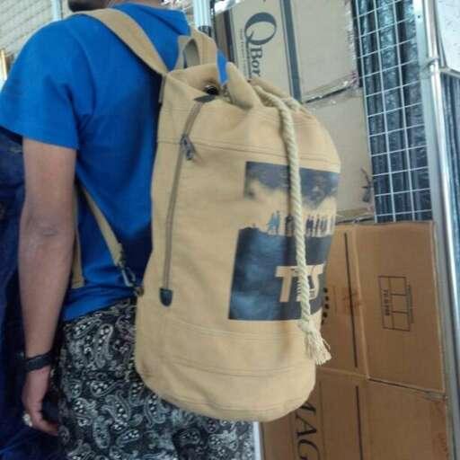 a man carrying a large bag on his back.