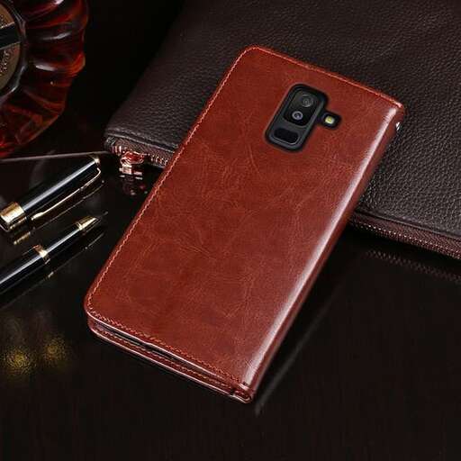 a leather wallet with a cell phone on it.