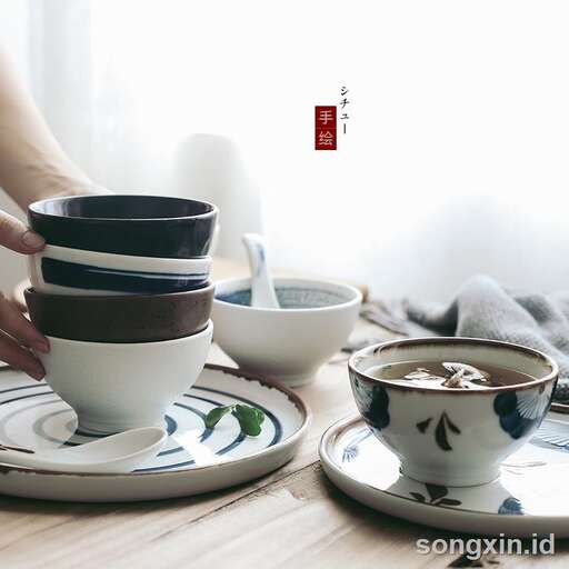a person sitting at a table with a cup of coffee.