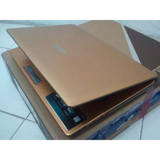 a laptop computer sitting on top of a cardboard box.