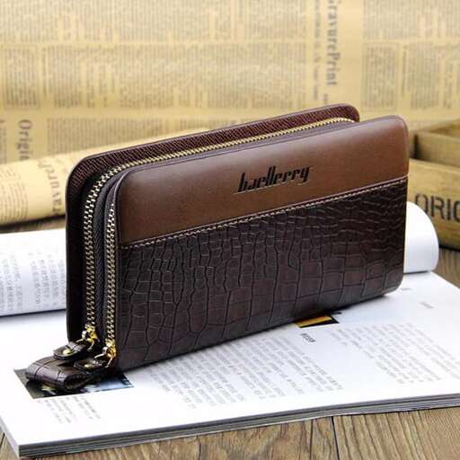 a brown leather wallet sitting on top of a book.