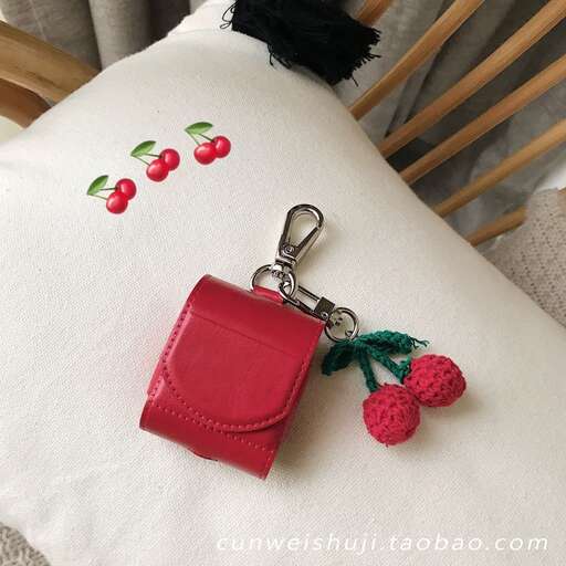 a keychain with a red berry on it.