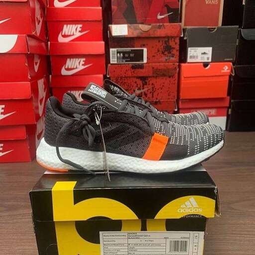 a pair of sneakers sitting on top of a shoe box.