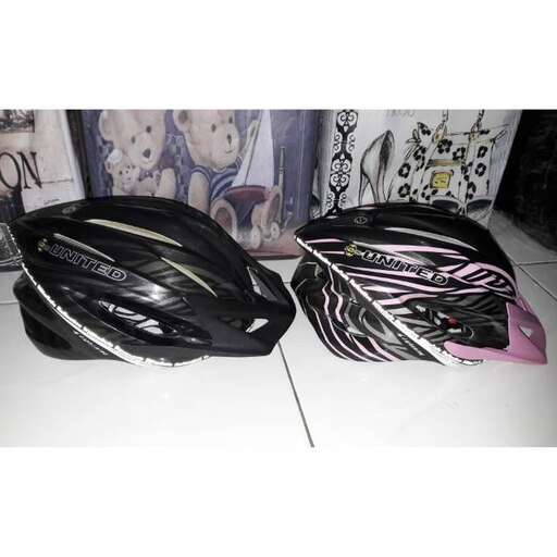 a pair of helmets with a pink and black design.