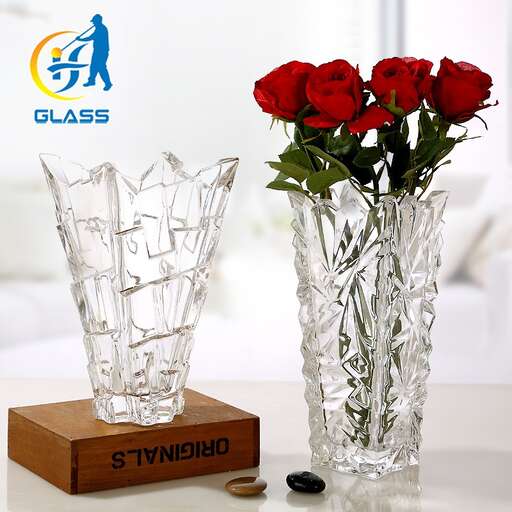 a vase of red roses on a table