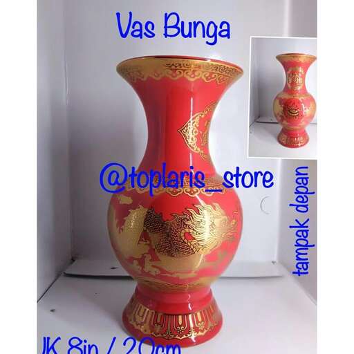 a large red vase sitting on a white surface.