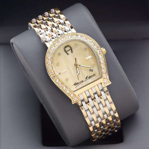 a watch with a yellow gold band.