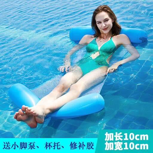 a woman in a green swimsuit floating in a pool