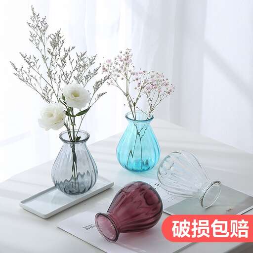 a table with three vases and a folded napkin.