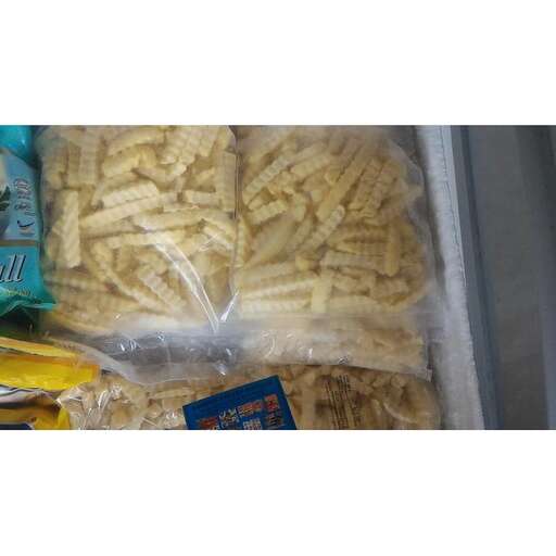 a plastic container filled with pasta and a package of pasta.