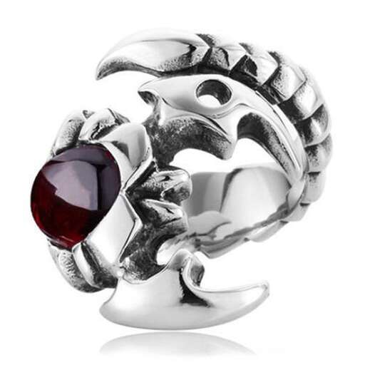 a ring that is made of sterling silver and is designed with a garnet.