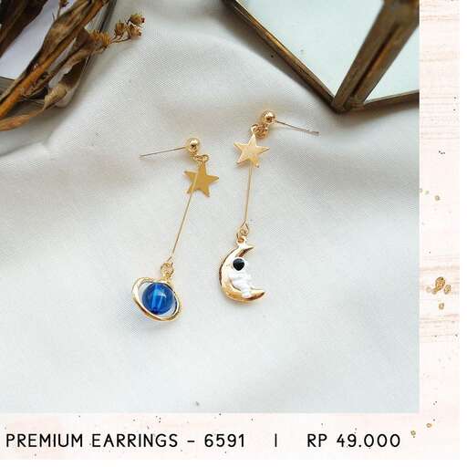 a pair of earrings with a blue moon and a moon in the sky