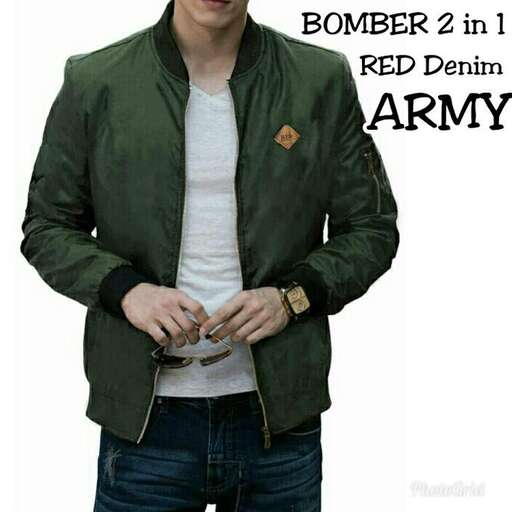 a man in a military jacket and jeans.