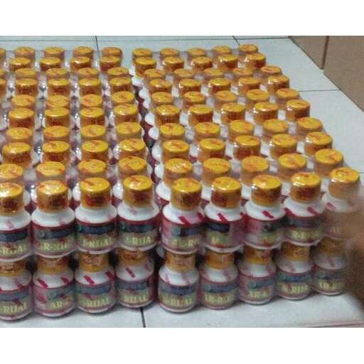 a stack of cans with a bottle of beer.