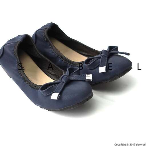 a pair of blue shoes with a letter on the front.