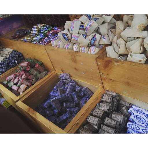 a display of chocolates and other snacks at a market.