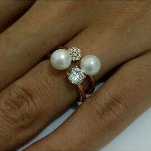 a ring with a pearl and diamond