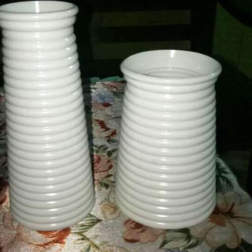 a table with three stacks of cups on it.