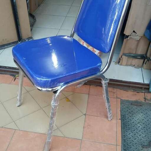 a blue chair sitting on top of a tile floor.