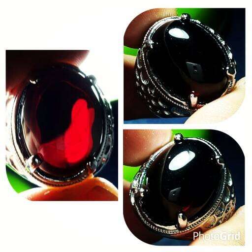 a red glass in a black and silver photo.