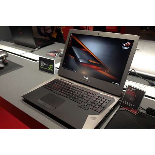 a laptop computer sitting on top of a desk.
