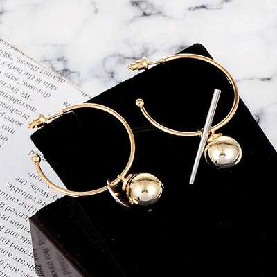 a pair of gold framed glasses on a book