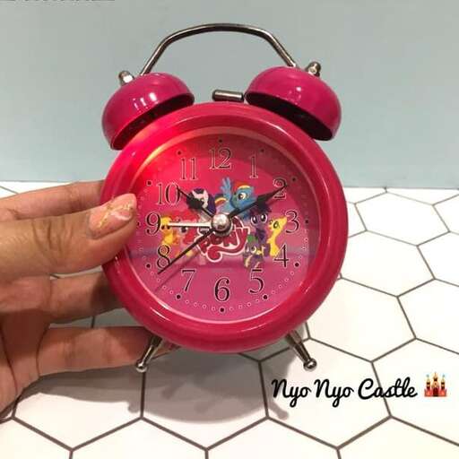 a clock with a pink alarm clock.