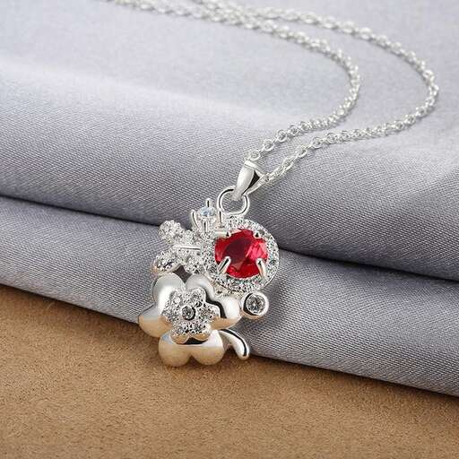 a necklace made of sterling silver and red glass beads.