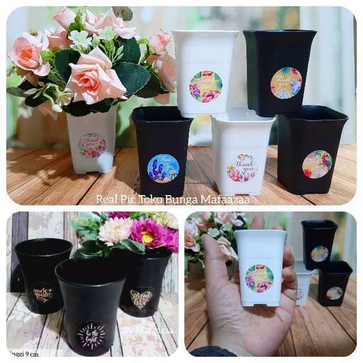 a hand holding a cup of flowers