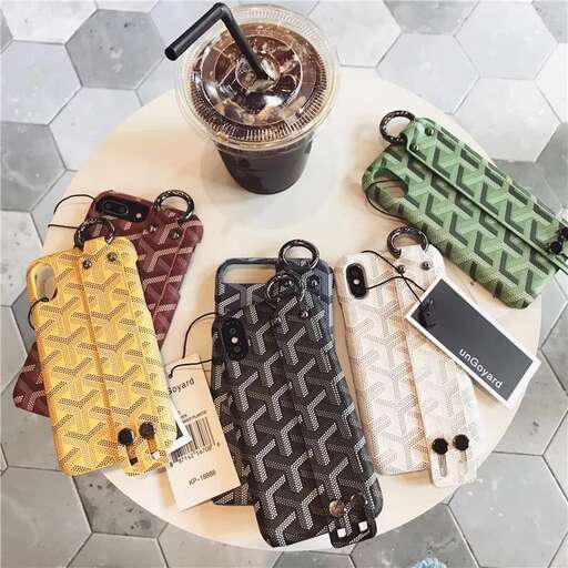 a table with a coffee cup and a cell phone on it.