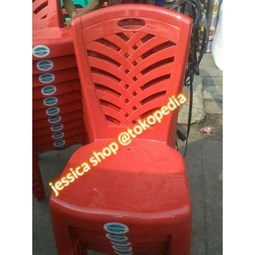a red plastic chair in a street market