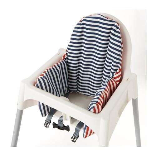 a white chair with striped blanket and striped socks.
