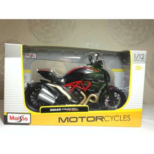 a motorcycle in a box on a white surface.