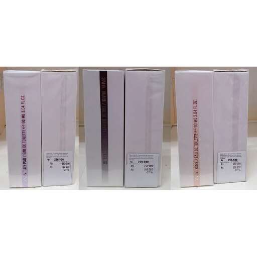 a row of three different colored boxes on a white counter.