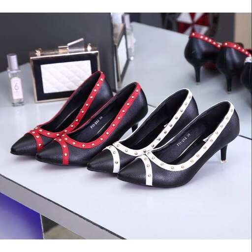 a pair of shoes on a table with a mirror.