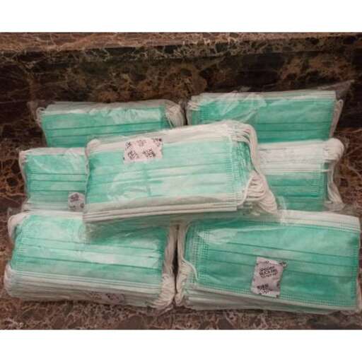a stack of green and white pillows.