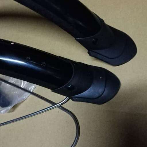 a pair of black and grey phone headset on a table.