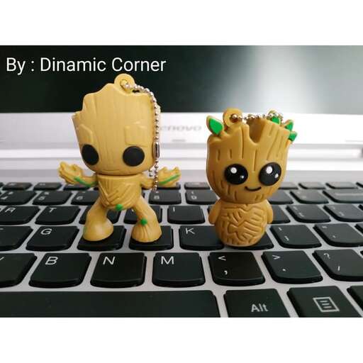 a small toy figurine of a stuffed animal on a laptop keyboard.