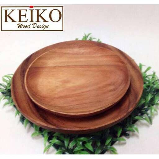 a wooden bowl with a lid and a green plant in the middle.