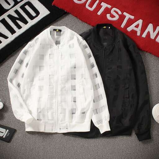 a white shirt and black jacket on a gray carpet
