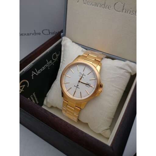 a gold watch in a box with pillows.