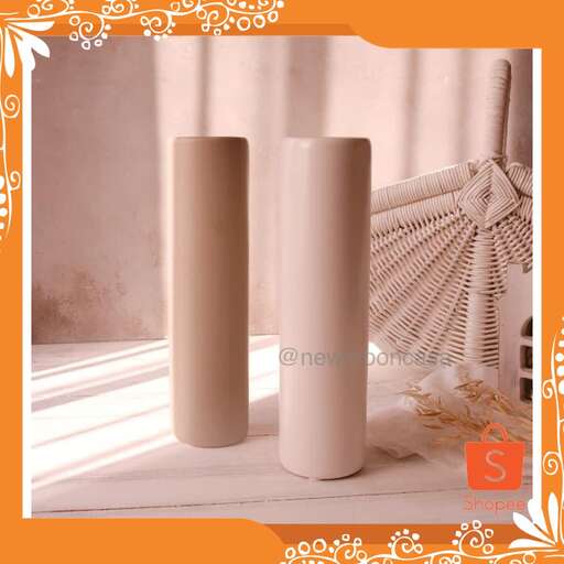 a set of three candles in a window box.