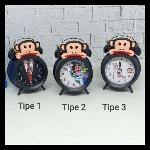 a set of three clocks with a monkey on them.