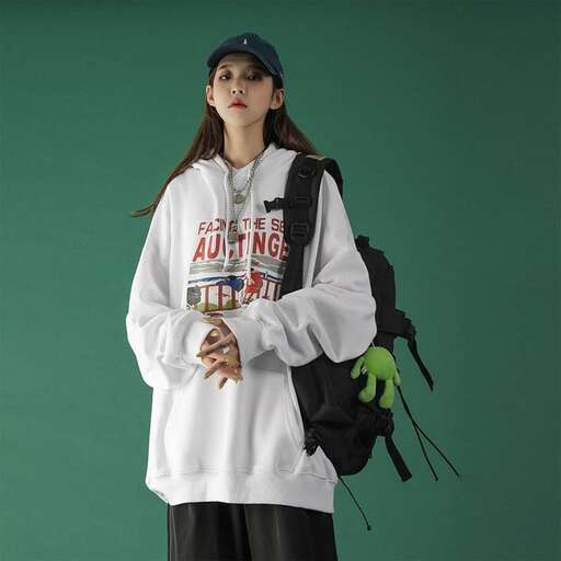 girl in white sweatshirt with green glove