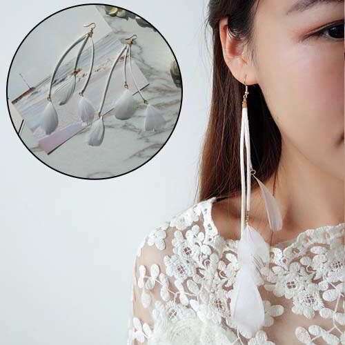 a girl in white dress with earrings