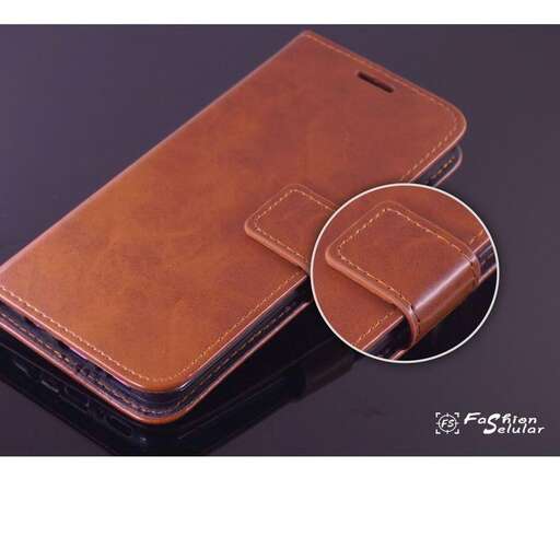 a brown leather case with a leather cover and a small leather case.