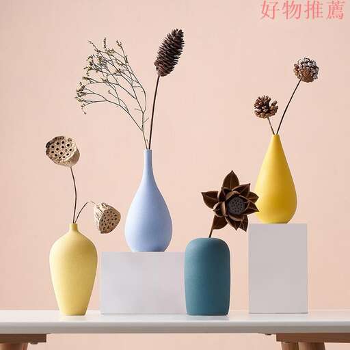 three vases with flowers in them on a table.