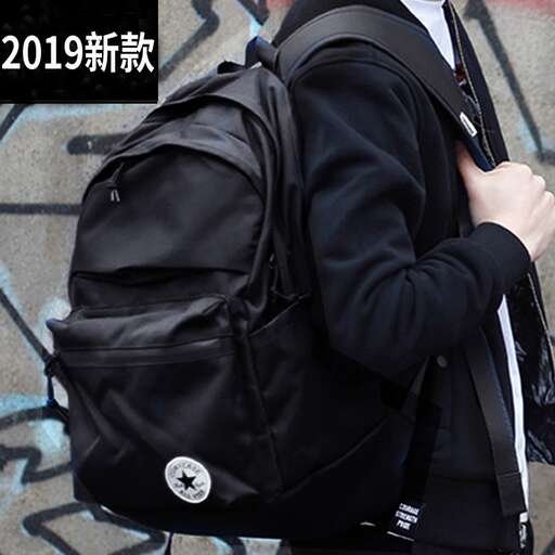 a man with a black backpack is carrying a black backpack.