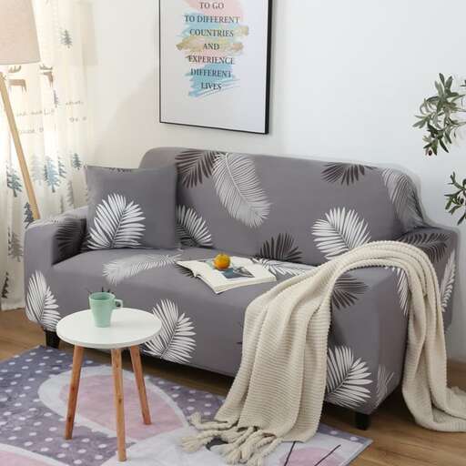 a couch with a plant on it and a lamp.